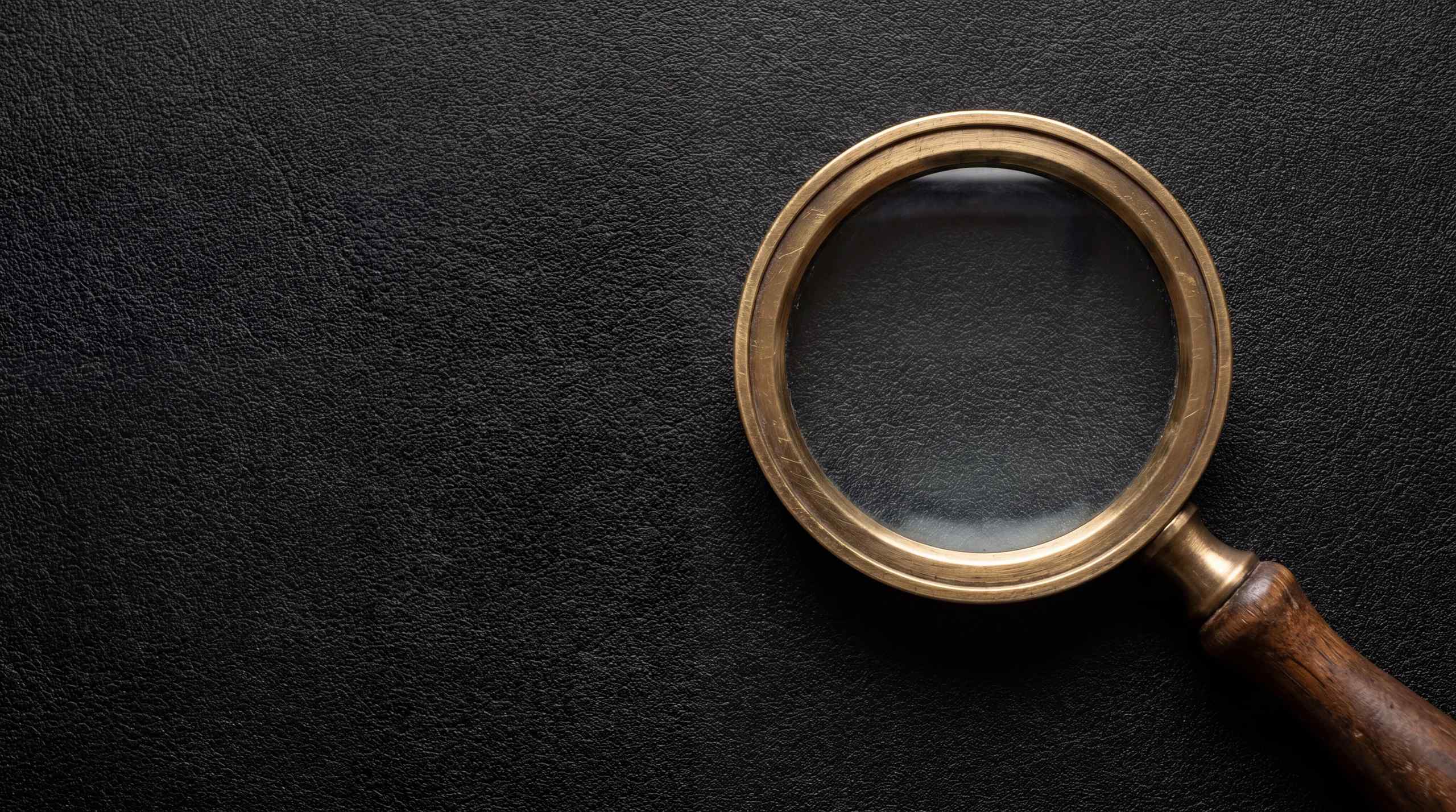 A magnifying glass on a black background